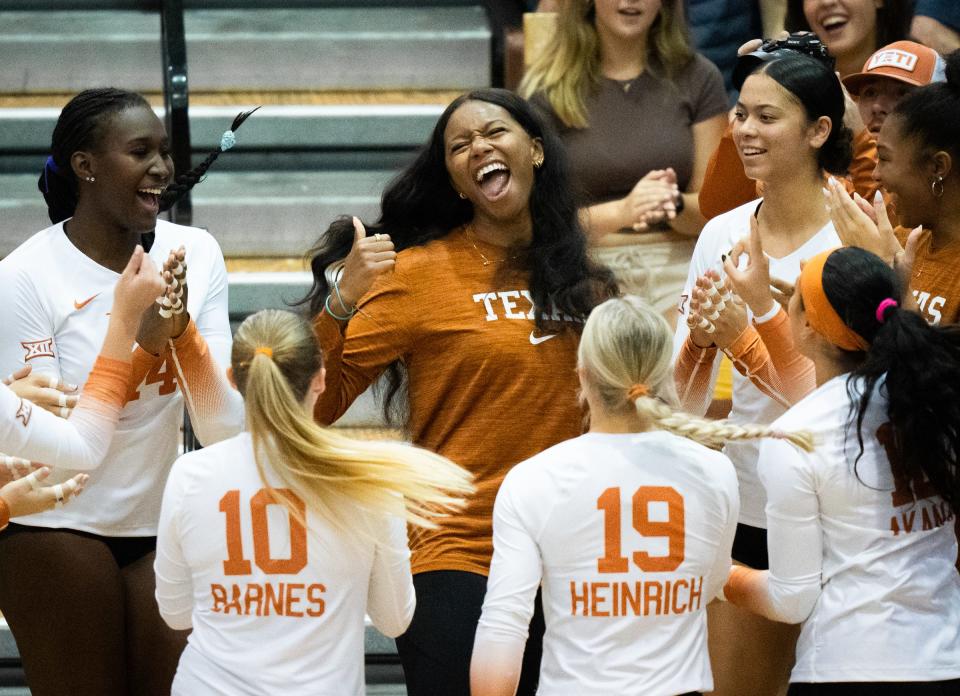 Texas middle blocker Asjia O'Neal, center, dances with the team as they get excited ahead of the Longhorn's match against Texas A&M-Corpus Christi in the Gregory Gymnasium, Aug. 18, 2023 in Austin. Texas won in three sets, but the two teams chose to play all five.