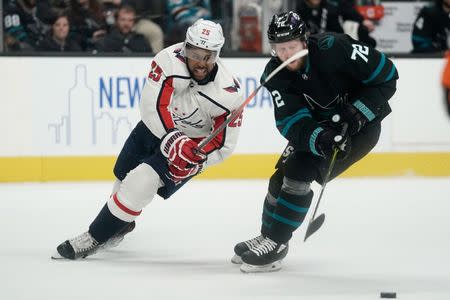 Feb 14, 2019; San Jose, CA, USA; Washington Capitals right wing Devante Smith-Pelly (25) fights for control of the puck against San Jose Sharks defenseman Tim Heed (72) during the third period at SAP Center at San Jose. Mandatory Credit: Stan Szeto-USA TODAY Sports