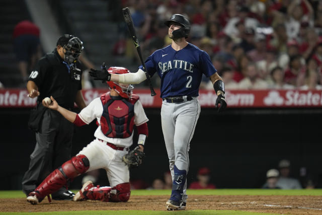 Los Angeles Angels' C.J. Cron (25) celebrates in the dugout after scoring  on a double by Mike Moustakas against the Seattle Mariners during the sixth  inning of a baseball game Thursday, Aug.