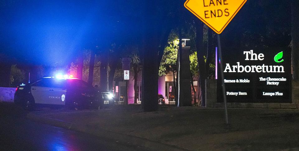 An Austin Police vehicle blocks an entrance to The Arboretum shopping center after a shooting that resulted in two deaths and multiple injuries on Thursday Aug. 31, 2023 in Austin.