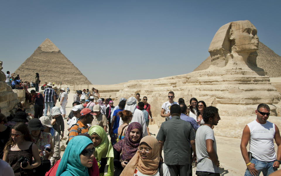 In this Thursday, Sept. 27, 2012 photo, foreign tourists visit the historical site of the Giza Pyramids, near Cairo, Egypt. The Egyptian demonstrations against an online film that was produced by a U.S. citizen originally from Egypt and denigrates the Prophet Muhammad were part of a wider explosion of anger in Muslim countries. They happened near the U.S. Embassy, far from the pyramids of Giza on Cairo's outskirts, and a lot further from gated Red Sea resorts, cocoons for the beach-bound vacationer. Yet the online or TV images _ flames, barricades, whooping demonstrators _ are a killjoy for anyone planning a getaway, even though the protests have largely subsided. Tour guides in Egypt say tourist bookings are mostly holding, but they worry about a dropoff early next year, since people tend to plan several months ahead.(AP Photo/Khalil Hamra)