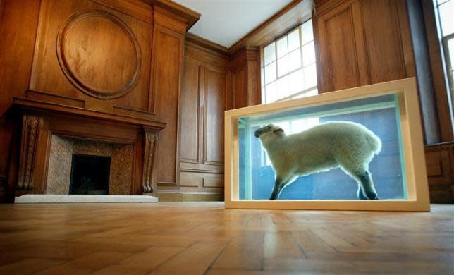 Damien Hirst's "Away From the Flock," a lamb preserved in formaldehyde in a steel and glass case, is seen on display at the new Saatchi Gallery in London, April 14, 2003.