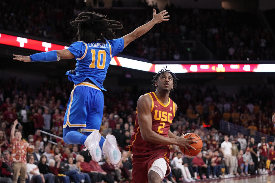 Southern California guard Reese Dixon-Waters (2) tries to shoot as UCLA guard Tyger Campbell (10) defends during the second half of an NCAA college basketball game Thursday, Jan. 26, 2023, in Los Angeles. (AP Photo/Mark J. Terrill)