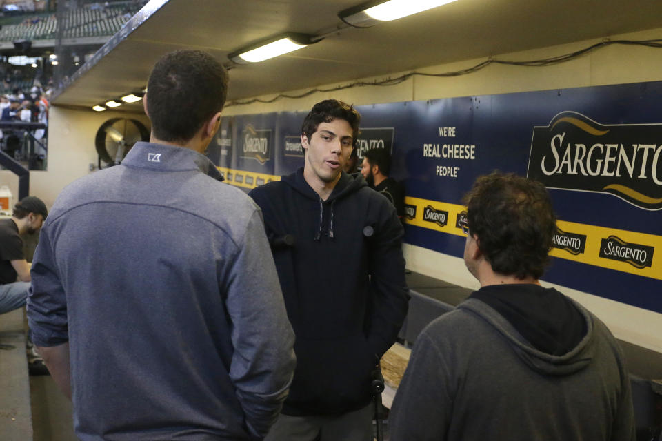 Milwaukee Brewers' Christian Yelich, center, talks with general manager David Stearns, left, and owner Mark Attanasio, right, before a baseball game against the Pittsburgh Pirates, Sunday, Sept. 22, 2019, in Milwaukee. (AP Photo/Aaron Gash)