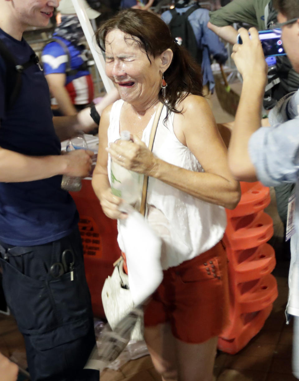 <p>Protesters leave the scene after Phoenix police used pepper spray outside the Phoenix Convention Center, Tuesday, Aug. 22, 2017, in Phoenix. Protests were held against President Donald Trump as he hosted a rally inside the convention center. (AP Photo/Matt York) </p>