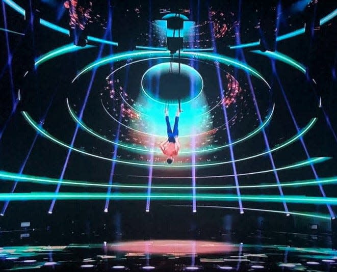 Aerialist Aidan Bryant, a Prince George, Va. native, hangs by his feet during his AGT: All-Stars 2023 Finals performance.