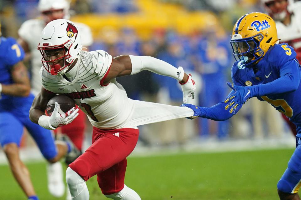 Pitt defensive back Phillip O'Brien Jr. tries to slow Louisville receiver Jamari Thrash (1). Thrash has posted solid numbers for the Cardinals after transferring from Georgia State.