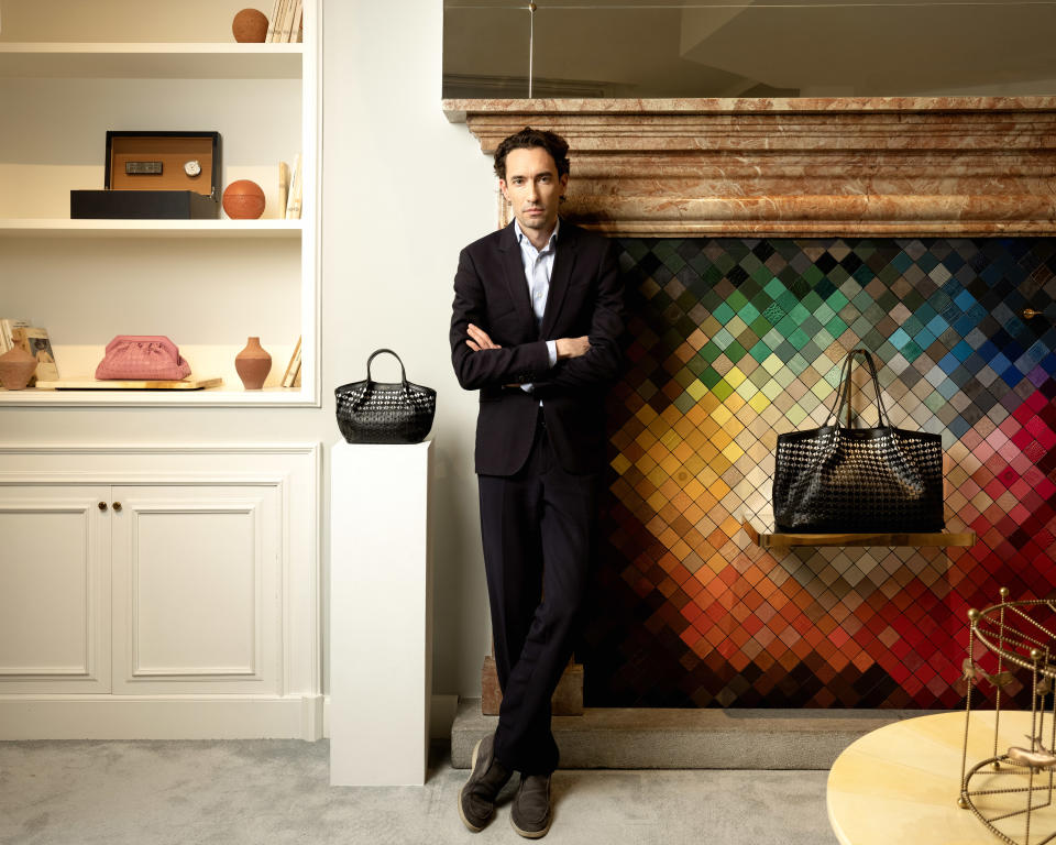 Maxime Bohe, CEO of Serapian, alongside the maison’s signature Mosaico leather weave bags.