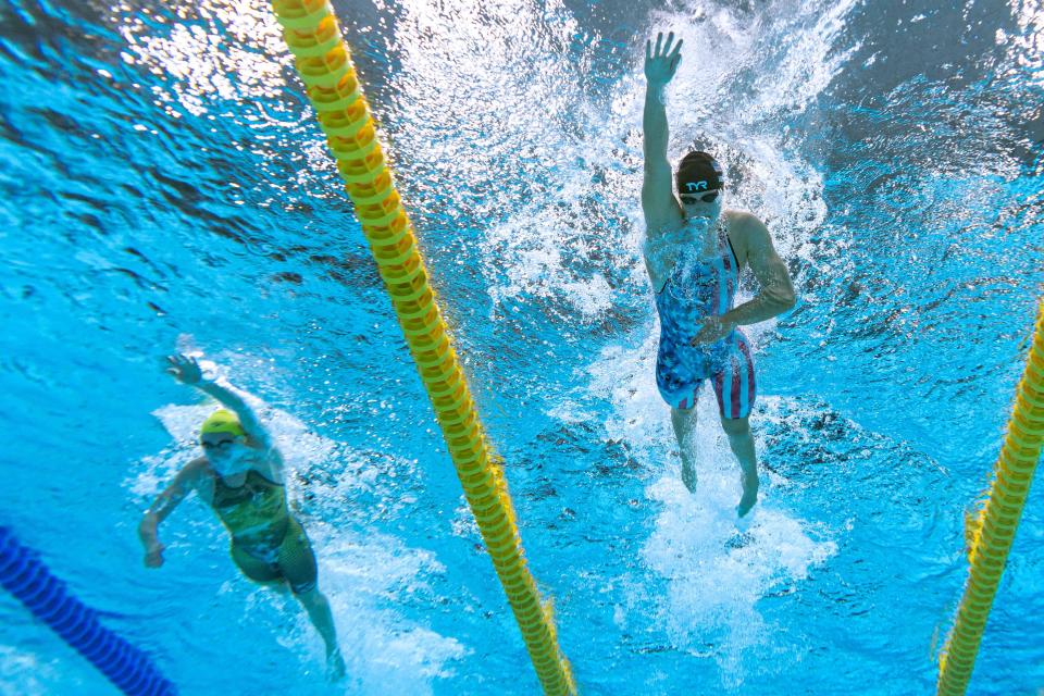 An underwater view shows Australia's Ariarne Titmus (L) and USA's Kathleen Ledecky as they compete to take gold and silver respectively in the final of the women's 400m freestyle swimming event during the Tokyo 2020 Olympic Games at the Tokyo Aquatics Centre in Tokyo on July 26, 2021.