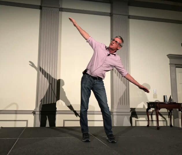 Planetary scientist Steve Squyres, who headed the science team for NASA’s Spirit and Opportunity rovers and now serves as Blue Origin’s chief scientist, demonstrates how the rovers were parked on slanted slopes to soak up maximum solar energy during the Martian winter. (GeekWire Photo / Alan Boyle)