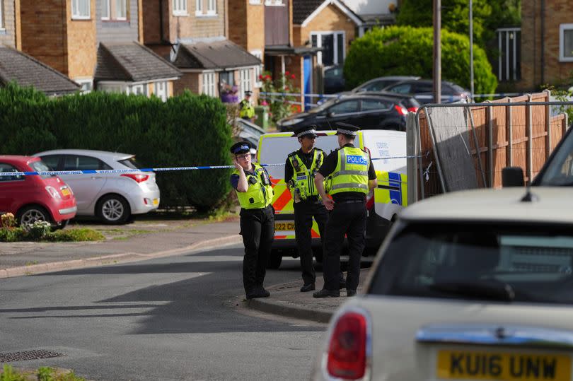 A view of police at the scene in Ashlyn Close, Bushey, Hertfordshire, where the wife and two daughters of a BBC sports commentator have been killed in a crossbow attack at their home