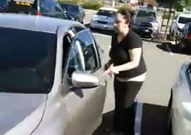 She returns to the car only to wind the windows up before heading back inside the store. Picture: Facebook/Manny Williams