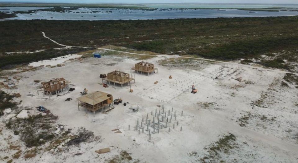 Shells of wooden structures, heavy machinery, concrete and metal pilings on the cleared site with Codrington Lagoon, an essential fishery for the island community, in the background (Global Legal Action Network)