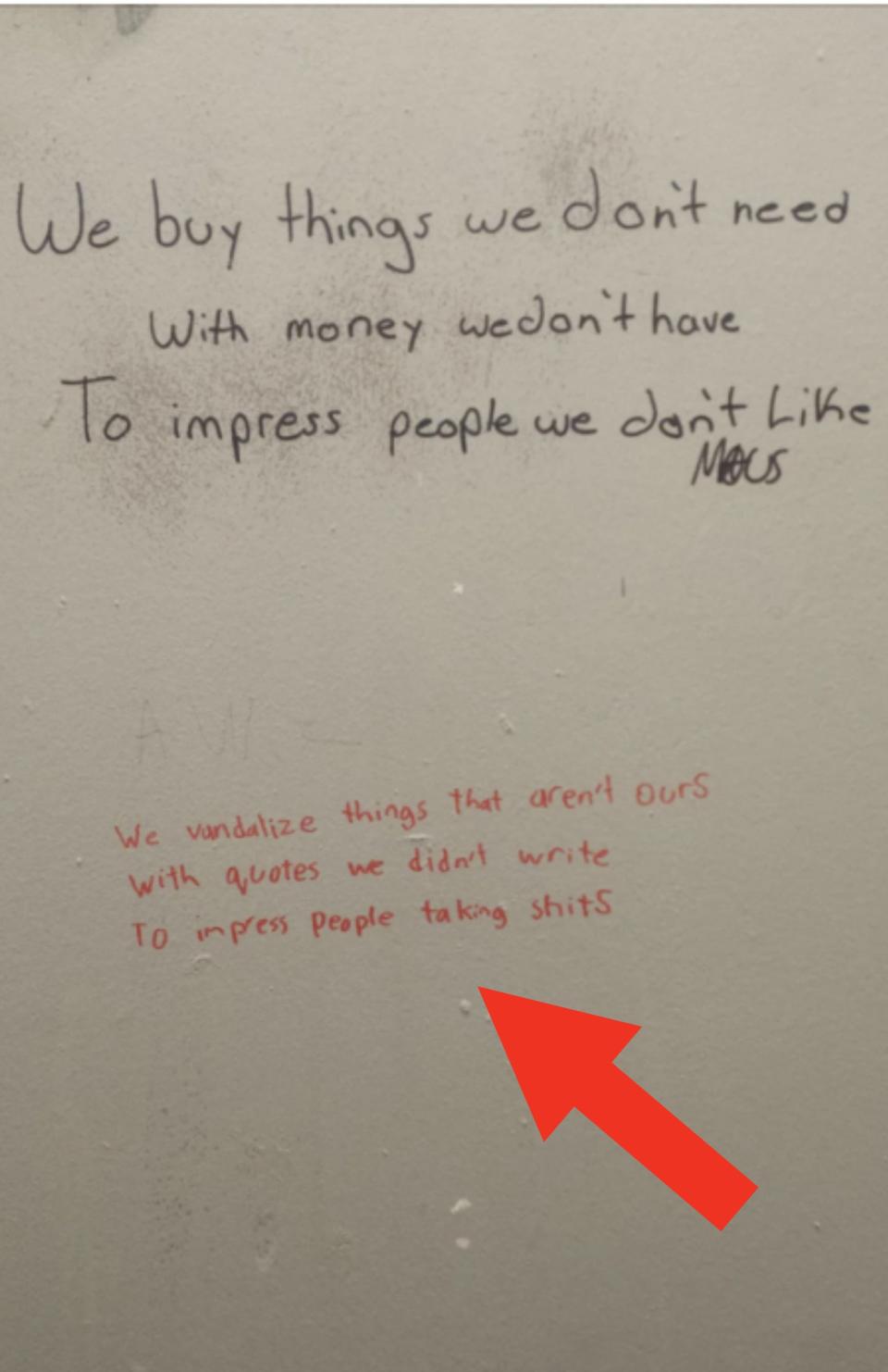 Graffiti on a wall reads: "We buy things we don't need with money we don't have to impress people we don't like." Below it: "We vandalize things that aren't ours with quotes we didn't write to impress people taking shits."