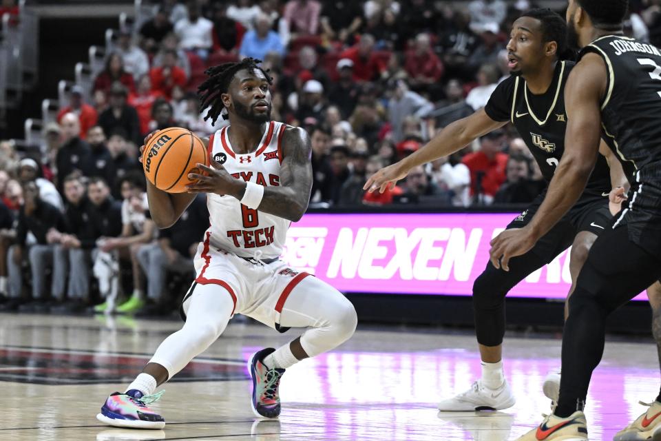 Texas Tech guard Joe Toussaint, left, brings the ball upcourt against Central Florida guards Shemarri Allen, second from right, and Darius Johnson, right, during the first half of an NCAA college basketball game, Saturday, Feb. 10, 2024, in Lubbock, Texas. (AP Photo/Justin Rex)