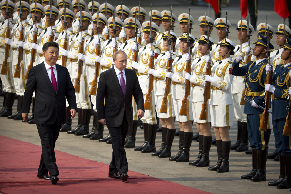FILE - Chinese President Xi Jinping, left, and Russian President Vladimir Putin review an honor guard during a welcoming ceremony at the Great Hall of the People in Beijing on June 25, 2016. Chinese President Xi Jinping was the son of a communist revolutionary leader, a victim of the Cultural Revolution and a provincial leader who promoted economic growth before ascending to the very top a decade ago. (AP Photo/Mark Schiefelbein, File)