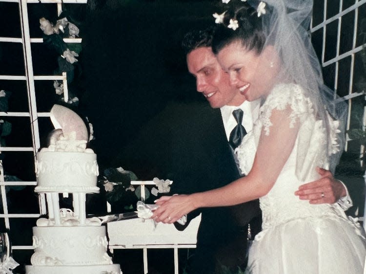 A bride and groom cut their wedding cake