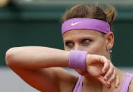 Lucie Safarova of the Czech Republic wipes her face during her women's quarter-final match against Garbine Muguruza of Spain during the French Open tennis tournament at the Roland Garros stadium in Paris, France, June 2, 2015. REUTERS/Gonzalo Fuentes