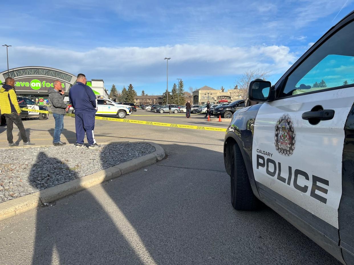 Police tape cordons off a scene where one person was killed by gunfire at the Trans Canada Centre in the city's northeast on Monday. (Jo Horwood/CBC - image credit)