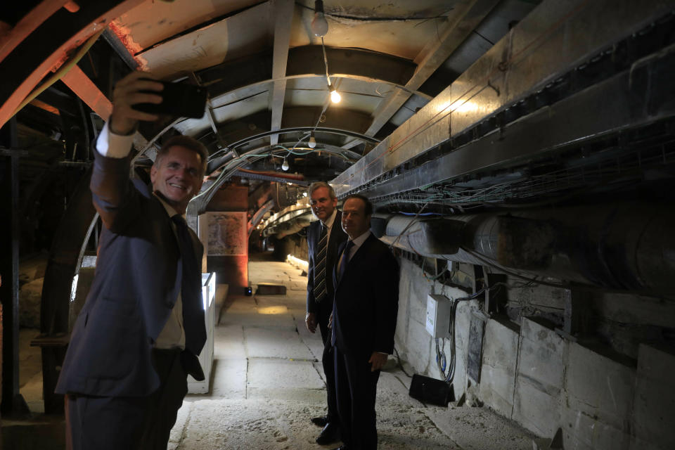 People take selfies inside an ancient tunnel during the opening of an ancient road at the City of David, a popular archaeological and tourist site in the Palestinian neighborhood of Silwan in east Jerusalem. The site is located on what many believe to be the ruins of the biblical King David's ancient capital and see as centerpieces of ancient Jewish civilization, but critics accuses the operators of pushing a nationalistic agenda at the expense of local Palestinian residents. (AP Photo/Tsafrir Abayov, Pool)