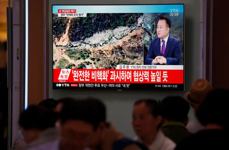 People watch a TV broadcasting a news report on the dismantling of the Punggye-ri nuclear testing site, in Seoul, South Korea, May 24, 2018. REUTERS/Kim Hong-Ji