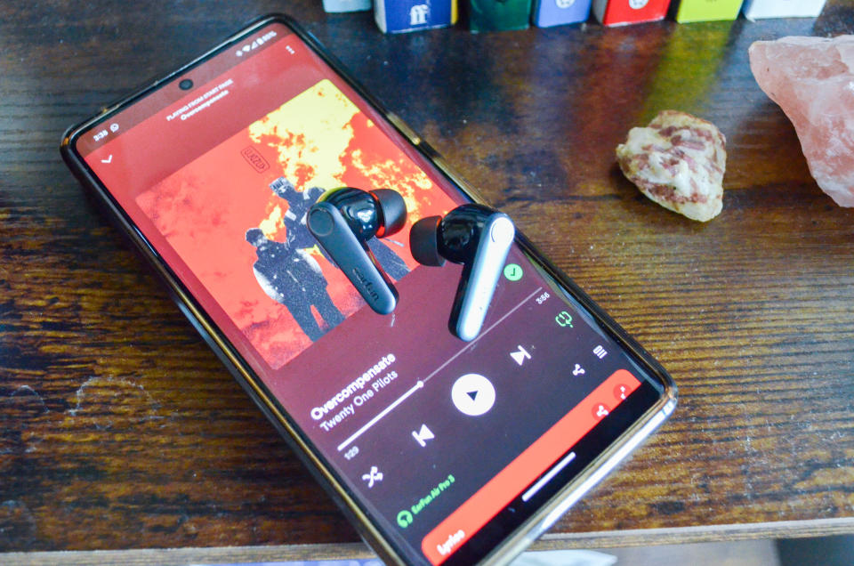 A photo of the EarFun Air Pro 3 on top of a PIxel Smartphone which is playing music