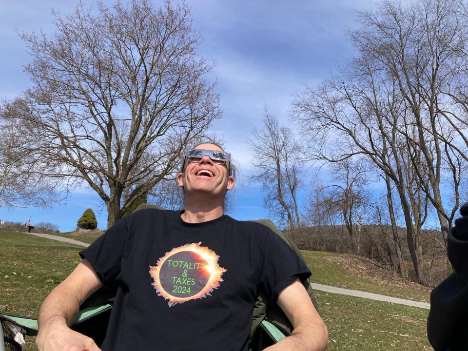 Nat Vander Els of St. George, Vermont dons a shirt appropriate for the eclipse and tax season Monday, April 8, 2024 at the Rocky Ridge Golf Course in St. George. Vander Els had just come from his job as a tax preparer in Williston to view the eclipse.