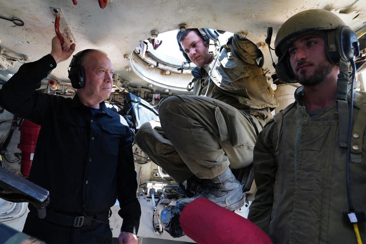 Israeli Defence Minister Yoav Gallant visits soldiers inside a self-propelled artillery howitzer at a position along the border with the Gaza Strip in southern Israel (Israeli Army/AFP via Getty Image)