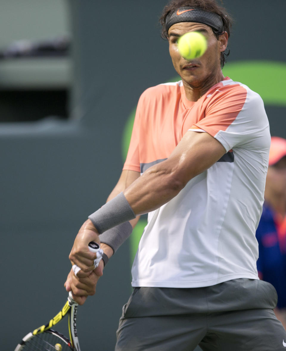 Rafael Nadal, of Spain, returns the ball to Denis Istomin, of Uzbekistan, during the Sony Open Tennis in Key Biscayne, Fla., Monday, March 24, 2014. Nadal won 6-1, 6-0. (AP Photo/J Pat Carter)