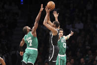 Brooklyn Nets forward Kevin Durant, center, shoots a 3-point basket against Boston Celtics guard Jaylen Brown (7) and forward Jayson Tatum (0) during the first half of an NBA basketball game, Sunday, Dec. 4, 2022, in New York. (AP Photo/Jessie Alcheh)