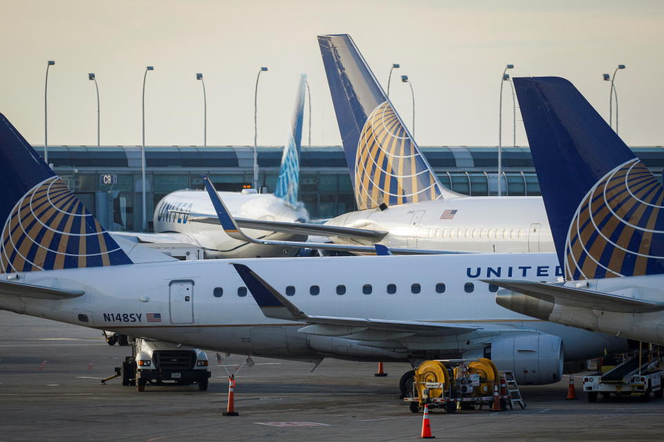United Airlines planes are parked at their gates at O'Hare International Airport ahead of the Thanksgiving holiday in Chicago, Illinois, U.S., November 20, 2021.  REUTERS/Brendan McDermid
