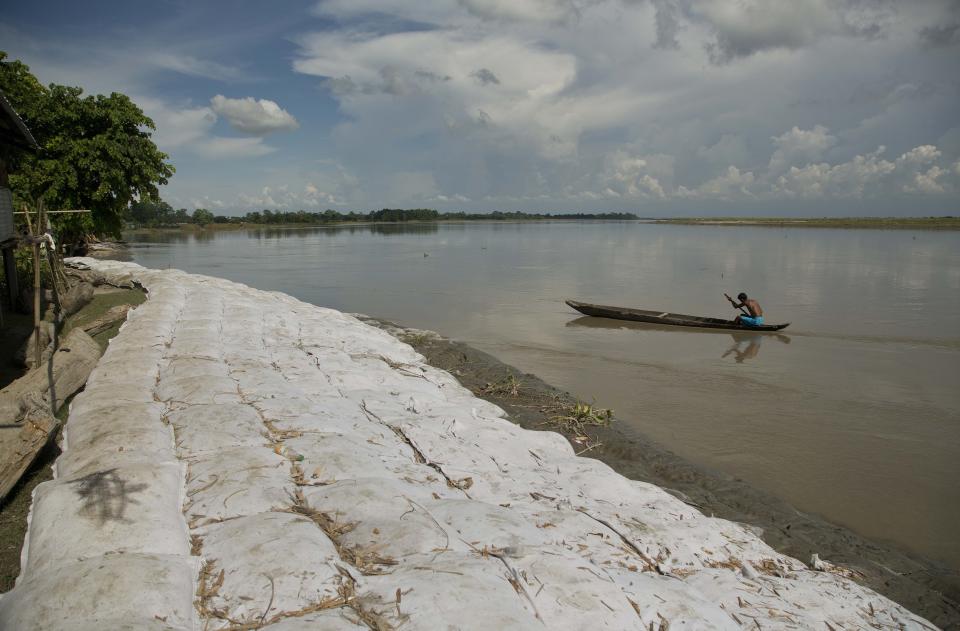 In this In this Aug. 6, 2018 photo, sandbags lie on the banks of the river Brahmaputra to help prevent erosion in Majuli in the northeastern Indian state of Assam. Majuli is said to be one of the largest river islands in the world, surrounded by the fast-moving waters of the massive, though braided, Brahmaputra river. Official estimates based on satellite data show that Majuli’s land mass decreased by more than 31 per cent between 1914 and 2004. (AP Photo/Anupam Nath)