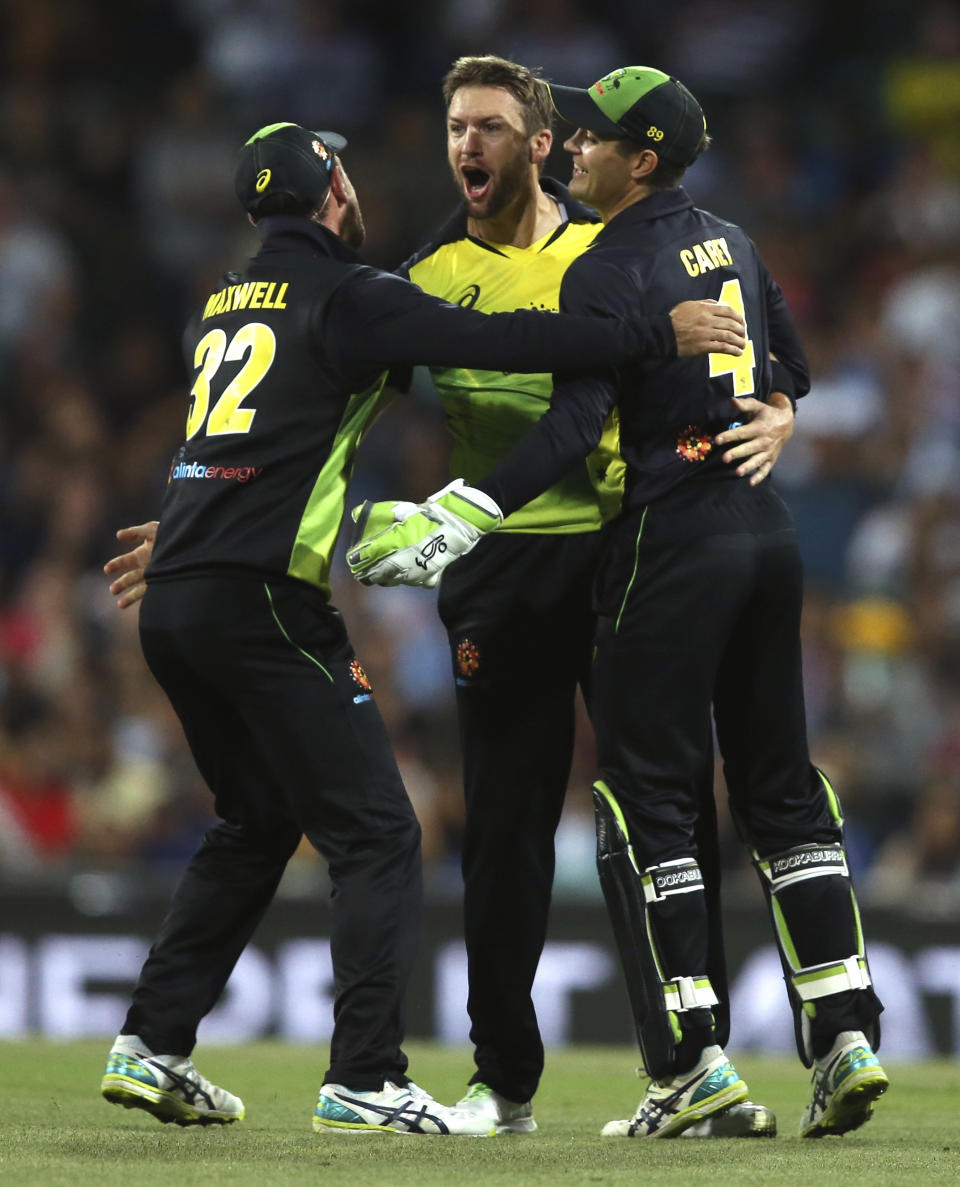 Australia's Andrew Tye, centre, is congratulated by teammates after dismissing India's Rishabh Pant during their Twenty20 cricket match in Sydney, Sunday, Nov. 25, 2018. (AP Photo/Rick Rycroft)