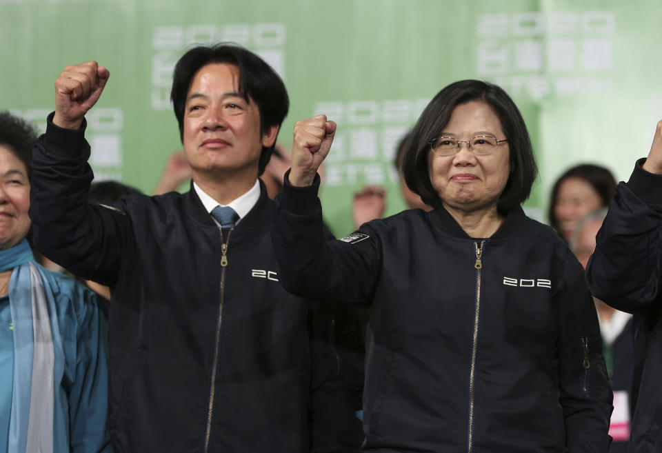 Taiwan's 2020 presidential election candidate, Taiwanese President Tsai Ing-wen, right, and her running mate William Lai celebrate their victory with supporters in Taipei, Taiwan, Saturday, Jan. 11, 2020. Taiwan's independence-leaning President Tsai Ing-wen won a second term in a landslide election victory Saturday, signaling strong support for her tough stance against China. (AP Photo/Chiang Ying-ying)