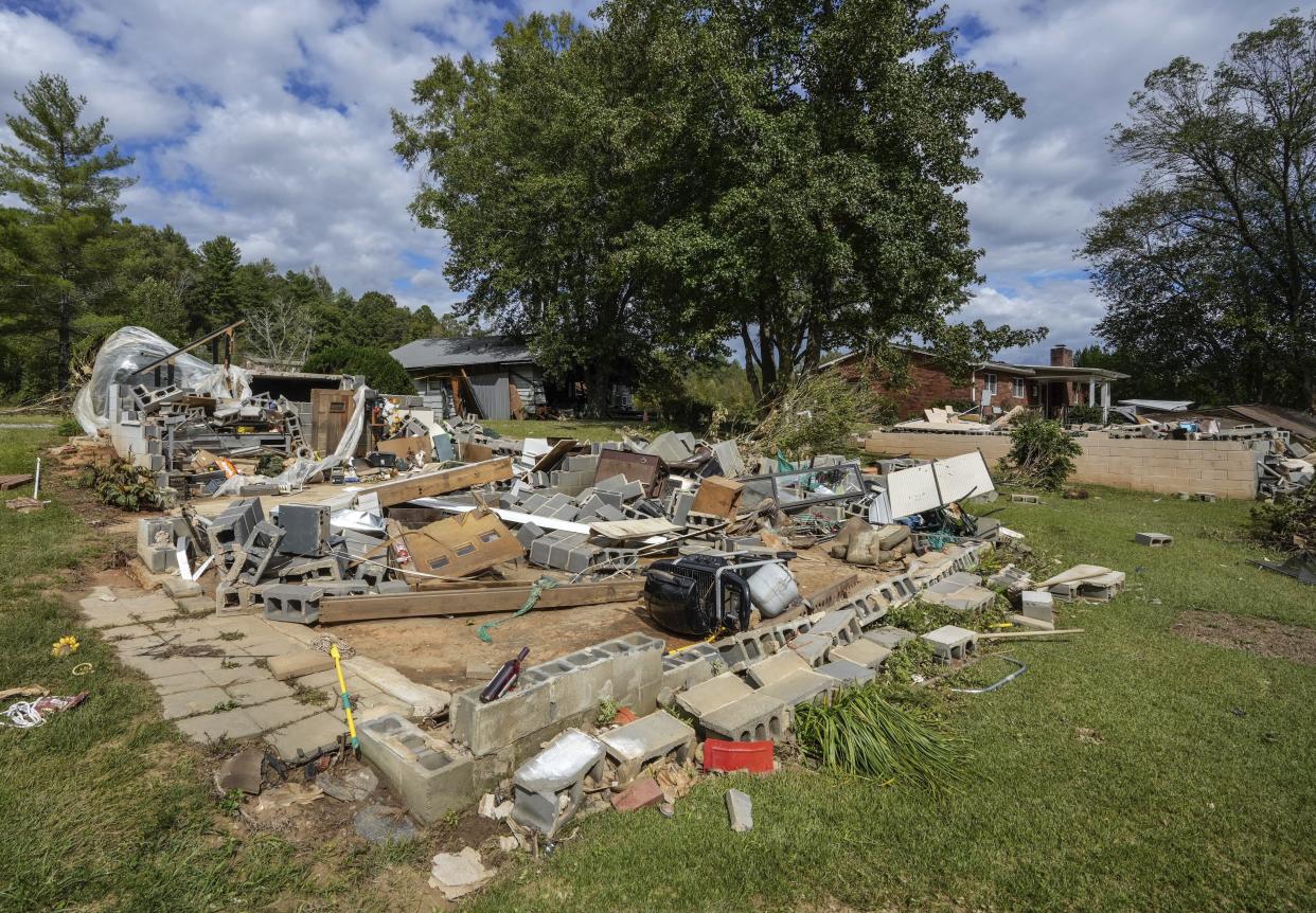 All that is left is the foundation of one of the White family homes, destroyed by Hurricane Helene, Tuesday, Oct. 1, 2024 in Morganton, N.C. The adjacent Catawba River flooded due to torrential rains destroying seven of the family's nine homes on the property. (AP Photo/Kathy Kmonicek)