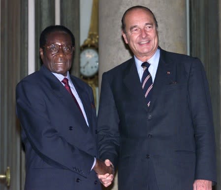 FILE PHOTO - French President Jacques Chirac (R) greets Zimbabwe's President Robert Gabriel Mugabe (L) at the Elysee Palace in Paris
