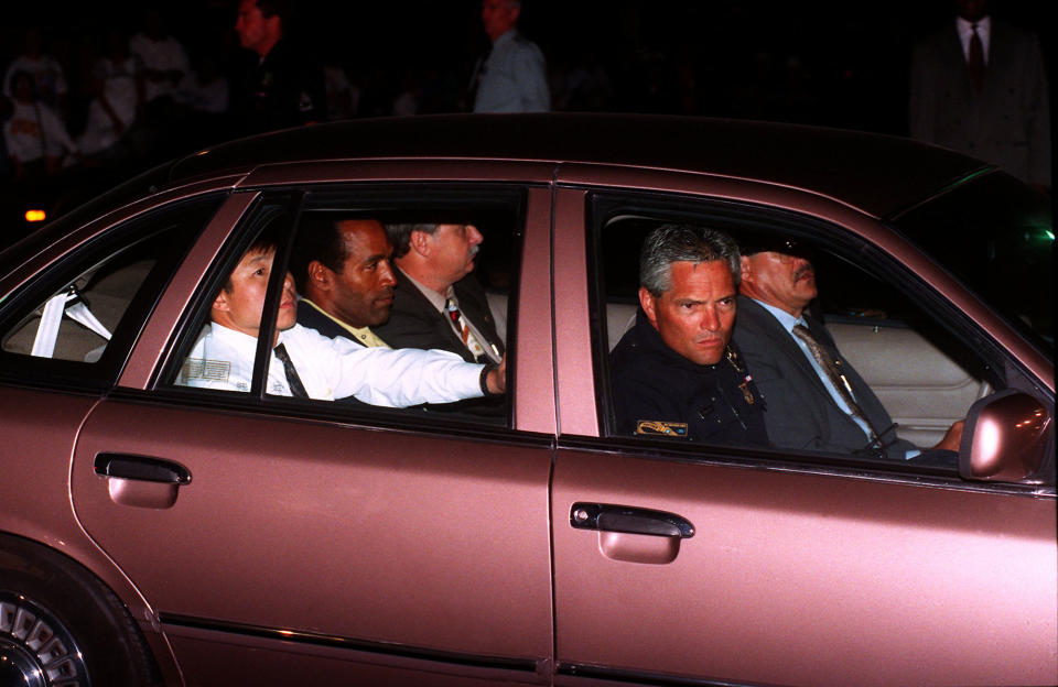 <p>O.J. Simpson, center of rear seat, is driven into the Los Angeles Police Department headquarters on Friday, June 17, 1994, after his arrest following a low-speed freeway chase which ended in the drive of his home in West Los Angeles. Simpson was charged with two counts of murder in connection with the slaying of his ex-wife Nicole, and Ron Goldman. (Photo: Bob Galbraith/AP) </p>