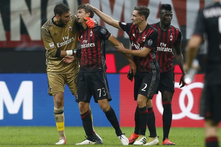 AC Milan's midfielder Manuel Locatelli (2ndL) celebrates with teammates after scoring on October 2, 2016