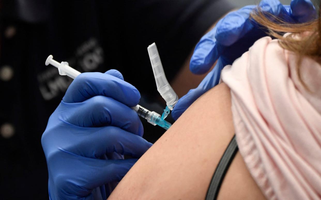Person receives vaccine - Patrick T. Fallon/AFP