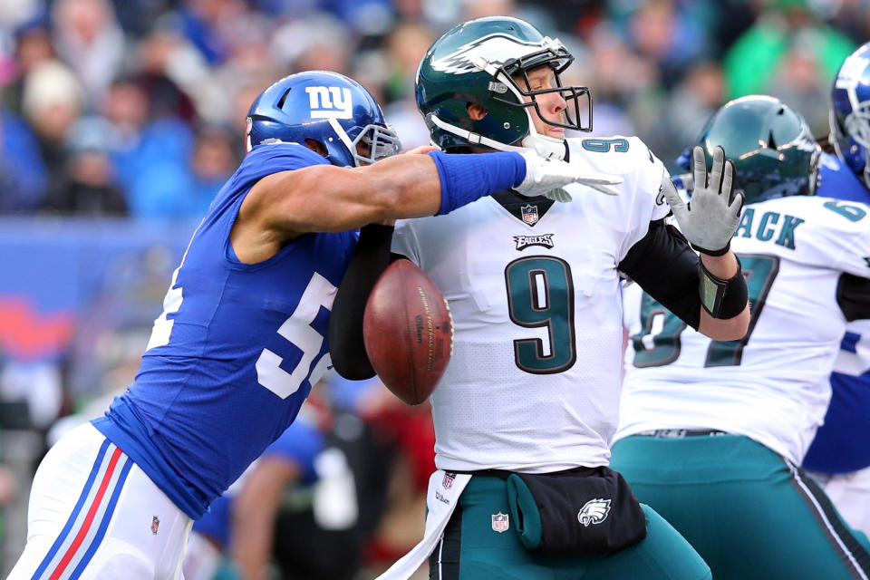 <p>Philadelphia Eagles quarterback Nick Foles (9) fumbles the ball as he is sacked by New York Giants defensive end Olivier Vernon (54) during the first quarter at MetLife Stadium. Mandatory Credit: Brad Penner-USA TODAY Sports </p>