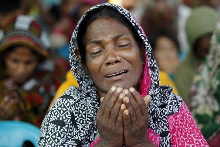 A relative of a garment worker, who went missing in the Rana Plaza collapse, takes part in a mass prayer on the first year anniversary of the accident, at a school in Savar April 24, 2014. REUTERS/Andrew Biraj