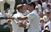 Novak Djokovic of Serbia shakes the hand of Jarkko Nieminen of Finland after winning their match at the Wimbledon Tennis Championships in London, July 1, 2015. REUTERS/Toby Melville