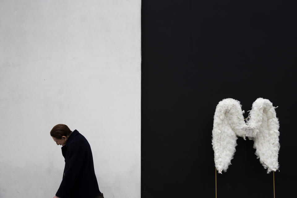 FILE - A man walks by a pair of angel wings displayed in a store in Beverly Hills, Calif., on Tuesday, May 7, 2019 (AP Photo/Jae C. Hong, File)