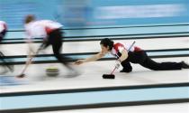 Canada's second Jill Officer (R) delivers a stone in their women's gold medal curling game against Sweden at the Ice Cube Curling Centre during the Sochi 2014 Winter Olympics February 20, 2014. REUTERS/Marko Djurica