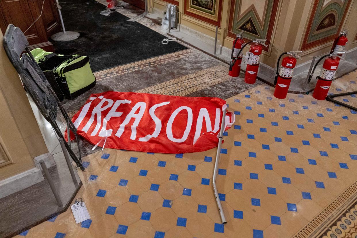 A flag that reads "Treason" is visible on the ground in the early morning hours of Thursday, Jan. 7, 2021, after protesters stormed the Capitol in Washington on Wednesday.