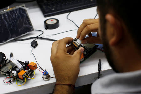 FILE PHOTO: An employee assembles an SkyAlert earthquake alarm device at the SkyAlert headquarters in Mexico City, Mexico October 9, 2017. REUTERS/Carlos Jasso/File Photo