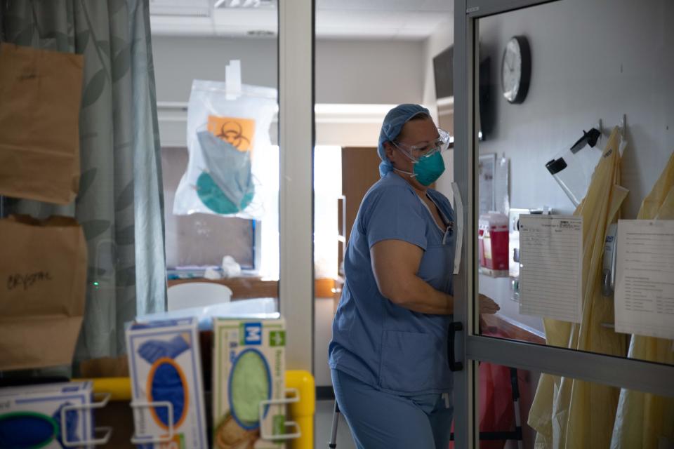 An Ohio healthcare worker exits a Covid-19 patient's room in the ICU.