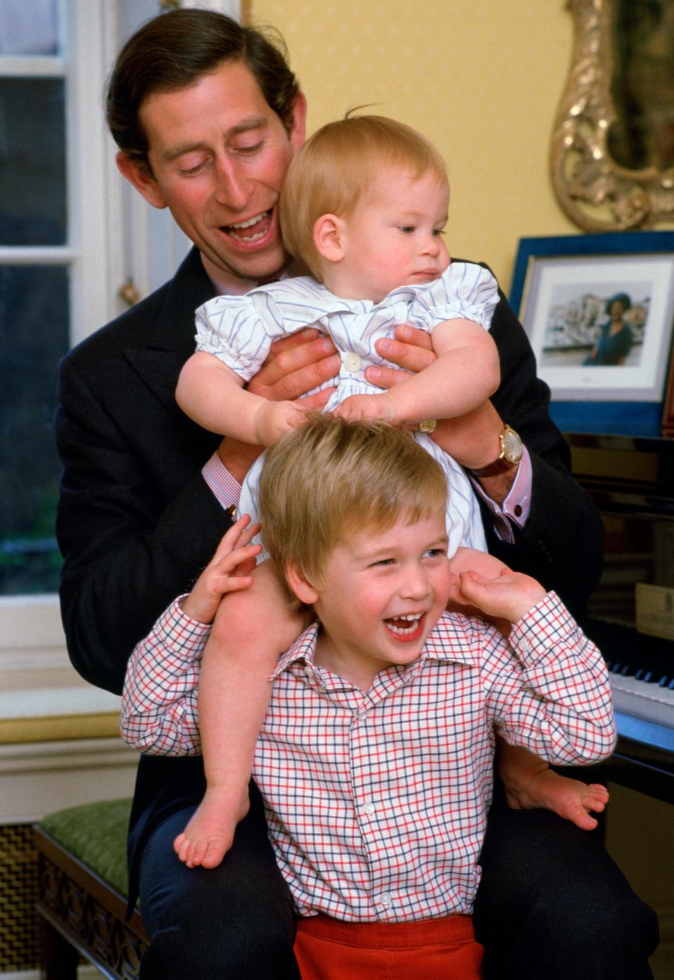 Prince Charles laughs with his young sons, Prince William and Prince Harry