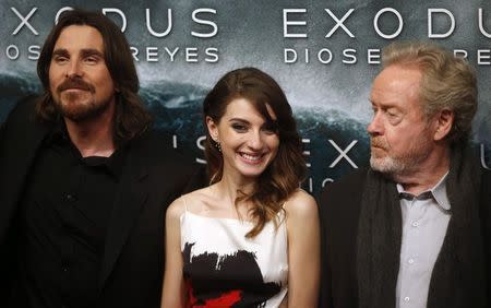 Director Ridley Scott (R) and cast members Christian Bale and Maria Valverde (C) pose for photographs as he arrive for the film world premiere of "Exodus: Gods and Kings" in Madrid , December 4, 2014. REUTERS/Juan Medina