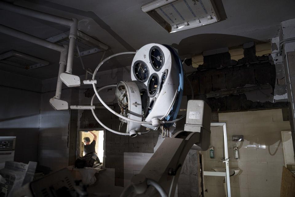 A volunteer boards up the windows inside the Okhmatdyt children's hospital a day after it was hit by Russian missiles, in Kyiv, Ukraine, Tuesday, July 9, 2024. (AP Photo/Evgeniy Maloletka)